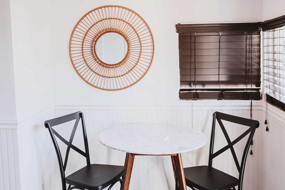 Sonomas Best Mercantile breakfast nook with two wooden chairs at a white table
